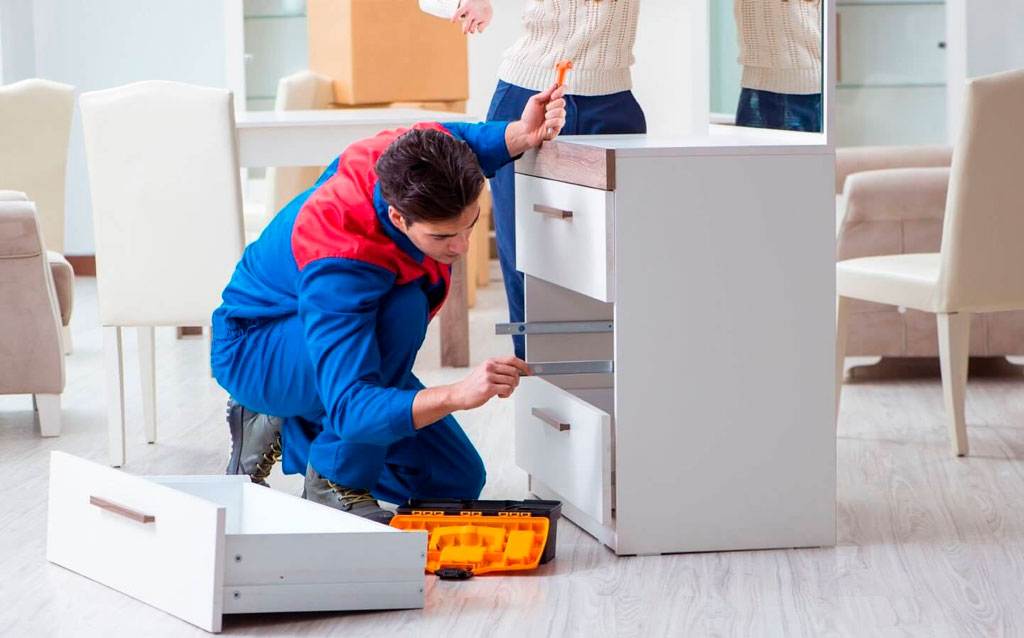 Oprava nábytku, muž spravuje dřevěnou tůmbočku